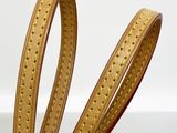 leather dog leash with gold stitching on a white background