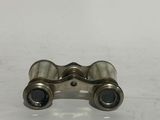 a close up of a pair of binoculars on a white surface