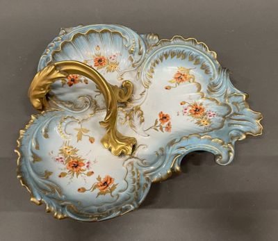 a blue and gold plate with a flower design on it