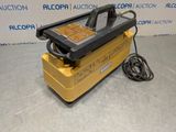 a close up of a machine on a table with a cord