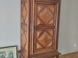 un grand meuble en bois dans le coin d'une pièce