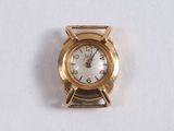 a gold clock that is on a white surface