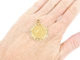 a woman ' s hand with a gold coin on it