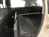 a trunk of a car with a luggage bag in the back