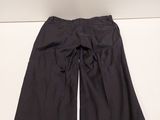 a pair of black pants sitting on top of a white table