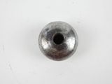 a close up of a metal bead on a white surface