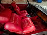 the interior of a car with red leather seats and a steering wheel