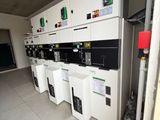 many machines that are lined up in a room