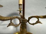 a brass candle holder with two candles on it