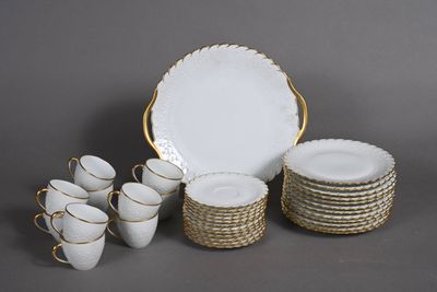 a lot of white plates and cups on the table