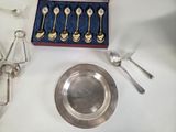 a silver plate with spoons and a silver plate with spoons and a silver plate with spoons and a silver plate with a spoon and a spoon
