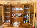 a china cabinet in the corner of the room