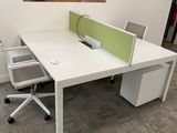 a white desk with a computer on top of it