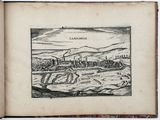 an old book with a drawing of a town in the middle of it