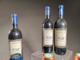 three bottles of wine that are sitting on a table