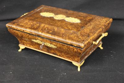 an old wooden box sitting on top of a black surface