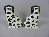 pair of black and white dog figurines on a white background