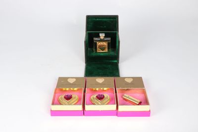 three boxes with rings inside of them on a white surface