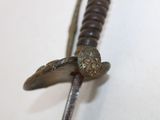 a close up of a metal object with a wooden bead on it