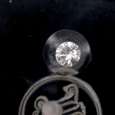 a silver ring with a diamond in it on a black background