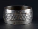 a close up of a ring on a table with a black background