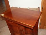 an image of a corner cabinet in the corner of a room