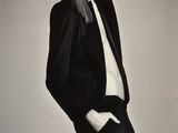 a black and white photo of a woman in a suit and tie
