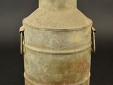 an old metal container with a handle on a black background