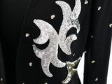 a close up of a black dress with gold sequins on it