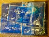 four packages of blue shirts in a box on a table