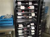 many bottles of wine on the shelves in the kitchen