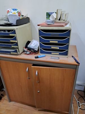 un bureau avec plusieurs tiroirs et une imprimante posée dessus