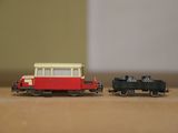 two toy trains sitting on a table next to each other
