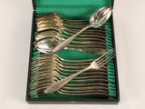 a lot of silver spoons and forks in a box