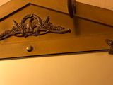 a mirror hanging on the wall with a bird on it