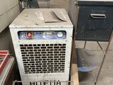 a stack of old refrigerators in a warehouse next to a metal rack