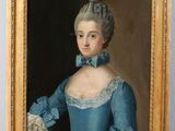 portrait of a lady in a blue dress by an easel