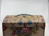a small box with flowers on it sitting on a table