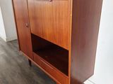 a wooden cabinet sitting on top of a hard wood floor