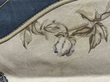 a close up of a purse with a flower design on it