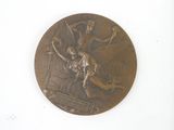 a bronze medal with a picture of a woman on it