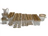 a group of gold and glass items sitting on top of a white surface