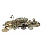 a pile of silver objects on a white surface