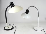 pair of black and white desk lamps on a white surface