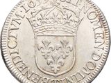 a close up of a silver coin with a crown on it