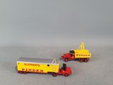 two toy trucks that are next to each other on a table