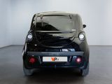 an image of a small black car parked in a room