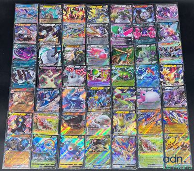 a large collection of pokemon cards sitting on top of a table
