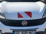 a white car with a red stripe on the front of it