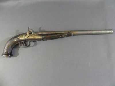 an old gun that is on display on a table